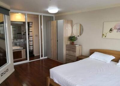 Compact bedroom with en-suite bathroom and wooden flooring