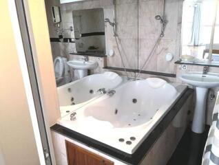 Modern bathroom with jacuzzi tub and dual sinks