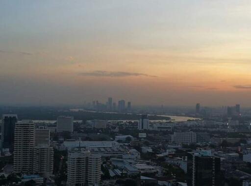 Aerial view of a cityscape during sunset with buildings and waterfront