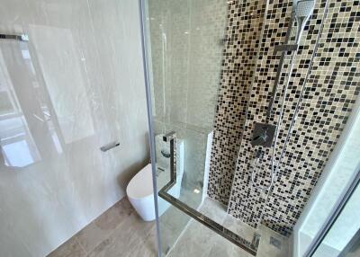 Modern bathroom with glass shower and mosaic tiles