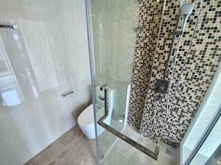 Modern bathroom with glass shower and mosaic tiles