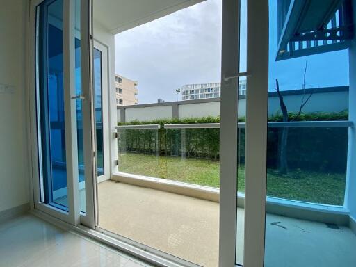 Balcony area with sliding glass door and view of a garden