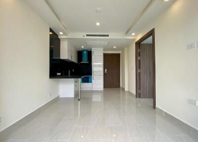 Modern kitchen with fitted appliances and tiled floor in new apartment