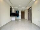 Modern kitchen with fitted appliances and tiled floor in new apartment