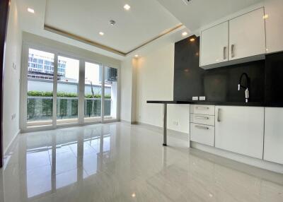 Modern kitchen with white cabinets and black countertops in a bright apartment