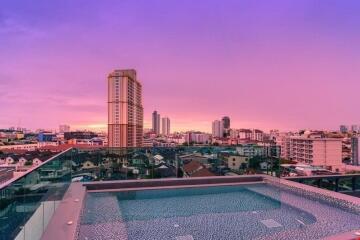 Rooftop swimming pool with city sunset view