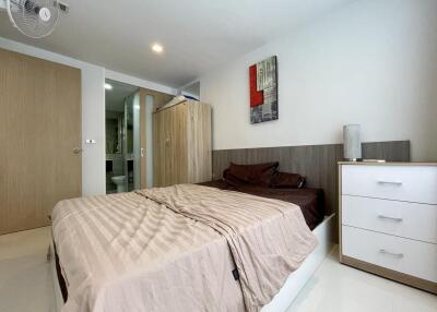 Modern bedroom interior with king-size bed and wooden furniture