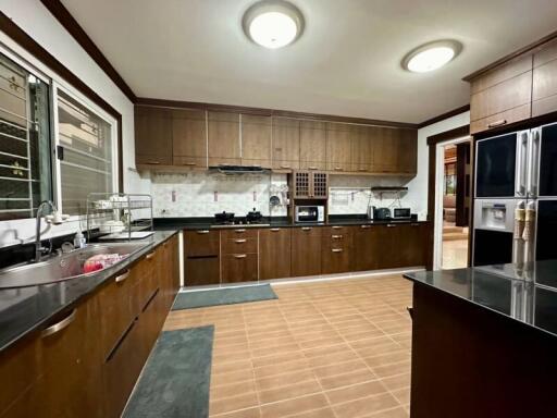 Spacious kitchen with wooden cabinets and modern appliances