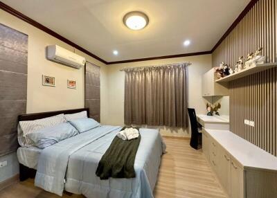 Cozy bedroom with modern design, queen-size bed, and air conditioning