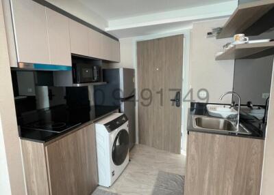 Modern kitchen with stainless steel appliances and wood cabinetry