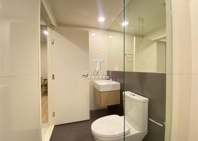 Modern bathroom interior with glass shower and white fixtures