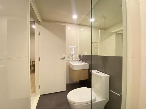 Modern bathroom interior with glass shower and white fixtures