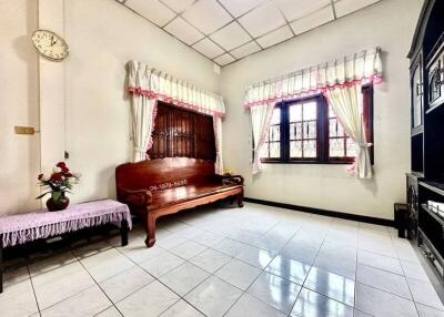 Spacious bedroom with traditional wooden bed and tile flooring