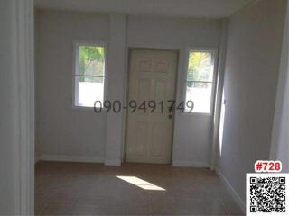 Bright and empty bedroom with tiled flooring and a view of palm trees through the window