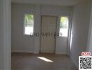 Bright and empty bedroom with tiled flooring and a view of palm trees through the window