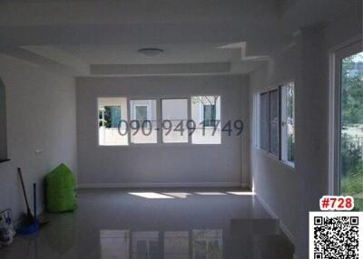 Spacious unfurnished living room with multiple windows providing natural light