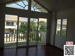 Spacious living room with large windows and ample natural light