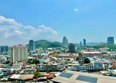 Panoramic view of a vibrant city with buildings under a clear blue sky