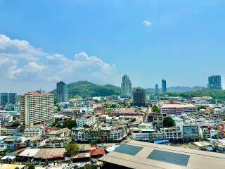 Panoramic view of a vibrant city with buildings under a clear blue sky