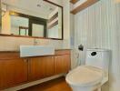 Modern bathroom interior with wooden cabinets and white fixtures