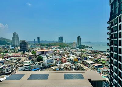 Panoramic city and sea view from high-rise apartment balcony