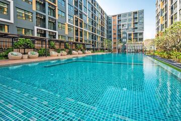 Modern residential apartment buildings with a shared swimming pool and leisure area