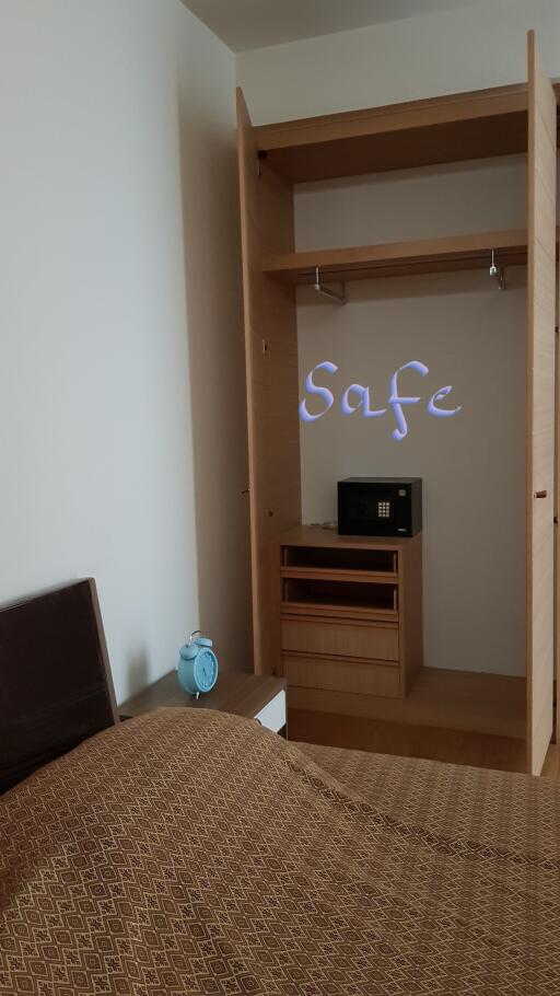 Cozy bedroom with built-in wardrobe and safe