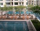 Swimming pool and lounging area in a residential complex courtyard