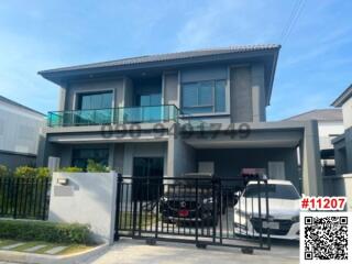 Modern two-story house with balcony and garage