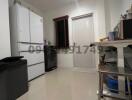 Compact kitchen with white appliances and tiled floor