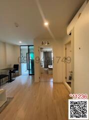 Interior view of a modern apartment showing the entrance and living area