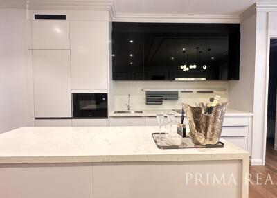 Modern kitchen with marble island and white cabinetry