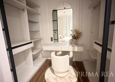 Modern hallway with built-in shelving and decorative chair