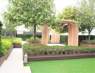 Elegant garden with wooden pergola and landscaped greenery