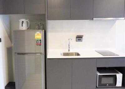 Modern kitchen with stainless steel appliances and gray cabinetry