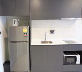 Modern kitchen with stainless steel appliances and gray cabinetry