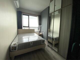 Modern bedroom with large window and mirrored wardrobe