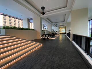 Spacious entryway with ambient lighting and staircase