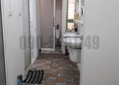 Compact bathroom with white fixtures and mosaic tiled floor