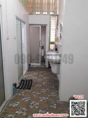 Compact bathroom with white fixtures and mosaic tiled floor