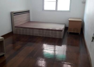 Spacious Bedroom with Wooden Flooring and Air Conditioning Unit