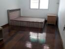 Spacious Bedroom with Wooden Flooring and Air Conditioning Unit