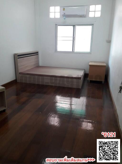 Spacious Bedroom with Wooden Flooring and Air Conditioning Unit