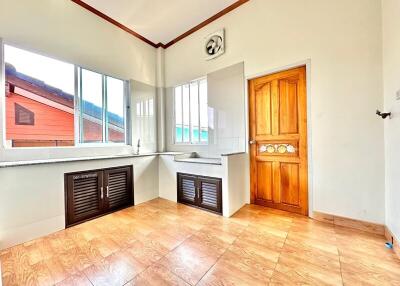 Bright kitchen with tiled floors and wooden cabinets