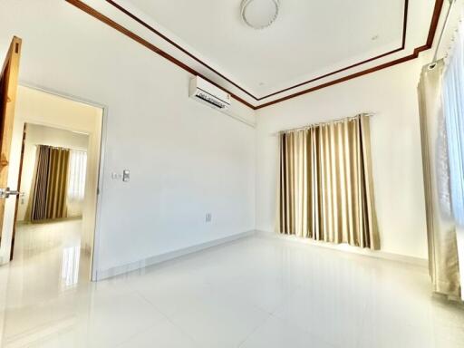 Spacious bedroom with natural light and modern air conditioning