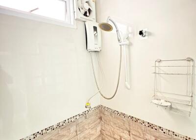 Compact bathroom with shower and white walls