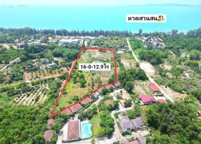 Aerial view of residential property with outlined boundary, pool and lush greenery