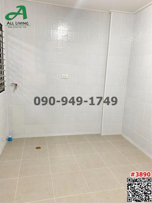 Clean and tiled bathroom with white walls