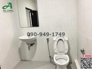 Modern bathroom with white fixtures and tiles