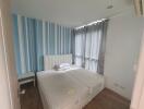 Cozy bedroom with twin beds and striped blue curtains